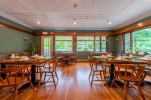 a dining room with wooden tables and chairs at Cranmore Mountain Lodge Bed & Breakfast in North Conway