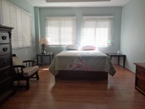 sypialnia z łóżkiem z 2 poduszkami i 2 oknami w obiekcie Santa Cruz Escape w mieście Santa Cruz