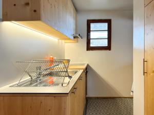 a kitchen with a dish drying rack on a counter at Chalet Marolly - Evolène in Evolène