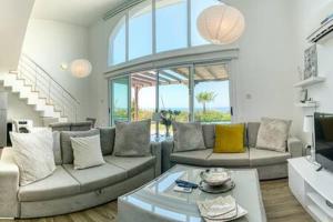 a living room with a couch and a coffee table at Joya Cyprus Sugarberry Garden Apartment in Saint Amvrosios