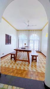 a living room with a table and two benches at Villa Ella in Mombasa