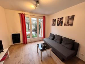 a living room with a couch and a table at F2 avec terrasse in Saint-Denis