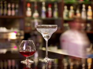 two wine glasses sitting on top of a bar at Focus Hotel Gdańsk in Gdańsk