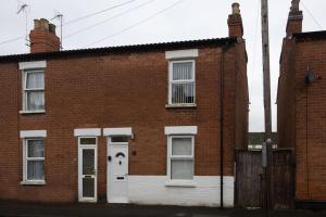 an old brick house with a white door at Birchmore House, by RentMyHouse 