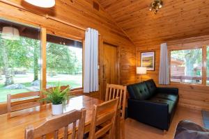 a dining room with a table and a chair at Pinecroft Lodges in Ingleton