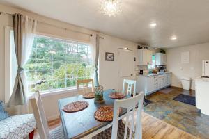 a kitchen and dining room with a table and chairs at The Sea Glass Cottage in Ocean Park