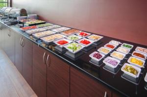 a buffet line with many different dishes of food at Focus Hotel Gdańsk in Gdańsk