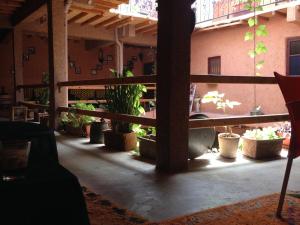 a patio with potted plants in a building at Riad assriir in Tiznit