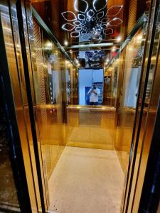 a man taking a picture in a glass case at HOLIDAYY INN in Prayagraj