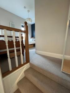 a hallway with stairs with a bed in the background at Hotel 50 in Bournemouth