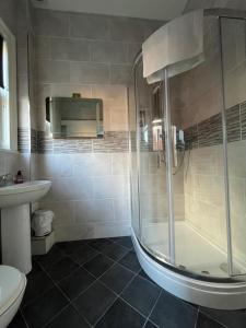 a bathroom with a shower and a toilet and a sink at Hotel 50 in Bournemouth