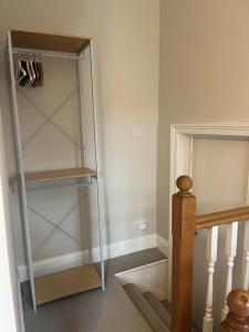 a glass cabinet in a hallway next to a staircase at Hotel 50 in Bournemouth +30 photos