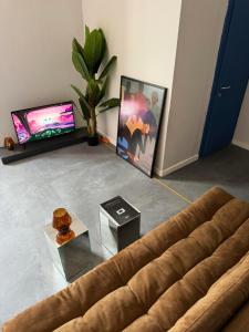 a living room with a couch and a tv at Etern Stays - PRN Apartment in Pristina
