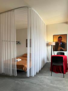 a bedroom with a bed and a canopy in a room at Etern Stays - PRN Apartment in Pristina