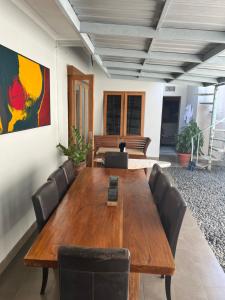 a conference room with a wooden table and chairs at Semesta Villa Jimbaran in Jimbaran