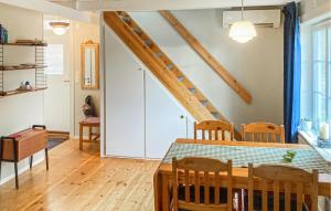 Lovely Home In Munka-ljungby With Wifi في Munka-Ljungby: غرفة طعام مع طاولة ودرج
