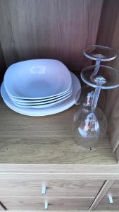 a stack of plates and dishes on top of a table at Heatherbrae Guest House in Kyle of Lochalsh