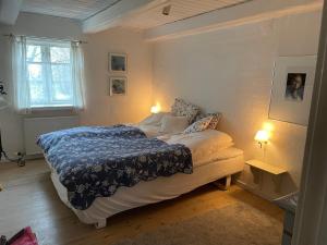 a bedroom with a bed and a window and two lamps at pallisgaard B&B in Struer