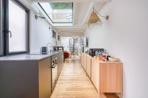 eine Küche mit Arbeitsflächen aus Holz und einem großen Fenster in der Unterkunft Loft proche Montparnasse in Paris