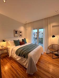 a bedroom with a large bed and a large window at O live Athens in Athens