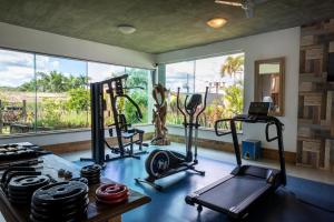 a gym with cardio equipment and a large window at Pousada Pequena Tiradentes in Tiradentes