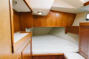 a small cabin with two beds in it at Sleep in boat in Catania