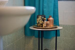 a small table with cosmetics on it in a bathroom at Casa Vacanze La Torre in Orio al Serio