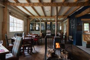 a restaurant with a fireplace in the dining room at The White Hart Ford in Ford