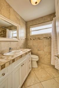 bagno con lavandino, servizi igienici e finestra di Incredible Beach Front Villa! a George Town
