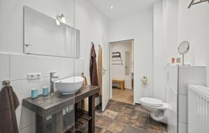 a white bathroom with a sink and a toilet at Ferienwohnung Maja in Loxstedt