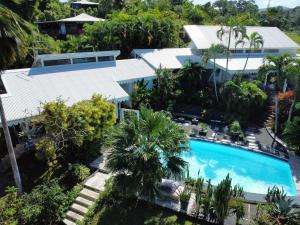 an aerial view of a resort with a swimming pool at Le Cottage in Sainte-Rose