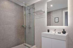 W łazience znajduje się prysznic i umywalka. w obiekcie Syntagma Unique Penthouse w Atenach