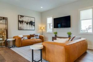 a living room with two couches and a tv at The Taylors - Grand Getaway for 22 in Germantown in Nashville