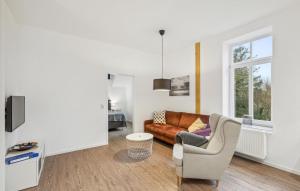 a living room with a couch and a chair at Ferienwohnung Maja in Loxstedt +18 photos