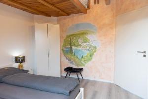 a bedroom with a mural on the wall at Wohnung am Bodensee in Moos