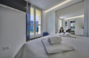 ein Schlafzimmer mit einem großen Bett und einem großen Fenster in der Unterkunft Majestic Sunrise Bellagio in Bellagio