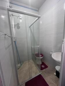 a bathroom with a shower with a toilet and a sink at casa de praia in Santos