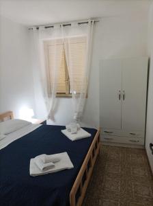 - une chambre avec un lit et 2 serviettes dans l'établissement SeaView Apartments Caprioli-Palinuro, à Palinuro