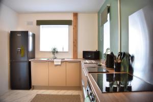 a kitchen with a black refrigerator and a window at Hermitage, 3 Bed entire House in Loughborough in Loughborough