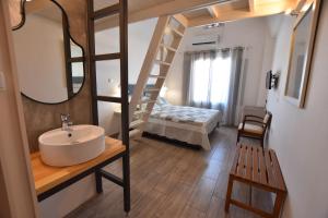 a bathroom with a sink and a bunk bed at Rodakas Hotel in Akrotiri