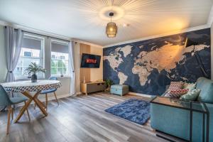 a living room with a map of the world on the wall at Central-1Bed Flat-Free Parking in Aberdeen