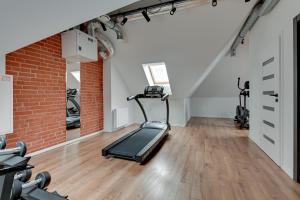 a gym with a treadmill and a brick wall at Waterlane Vintage - Fitness & Gym by Blue Mandarin in Gdańsk
