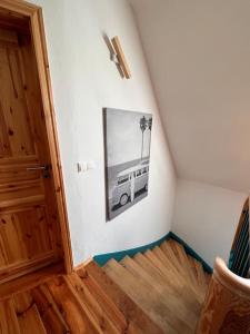 an attic room with a picture of a bus on the wall at Kleine Auszeit im Seenland in Hohenbocka
