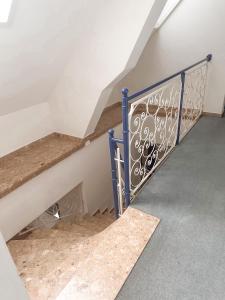 a set of stairs with a blue gate in a room at Gasthof & Buschenschank Windisch in Gundersdorf