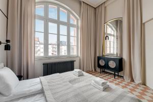 a bedroom with a large bed and a large window at Waterlane Vintage - Fitness & Gym by Blue Mandarin in Gdańsk
