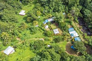 an overhead view of a farm with tents in the forest at 3 Rivers Eco Lodge in Rosalie