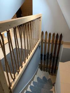 a staircase with a bunch of weapons on the wall at Bacówka Na Bundówkach in Zakopane