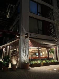 a building with plants in front of it at night at Stylish Brentford Riverside Penthouse in Brentford