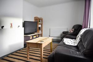 a living room with a couch and a table at Hermitage, 3 Bed entire House in Loughborough in Loughborough