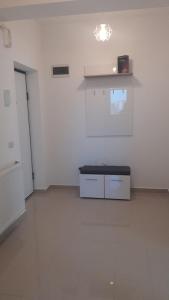 a white room with a table and a shelf on the wall at IN APART HOTEL in Bucharest